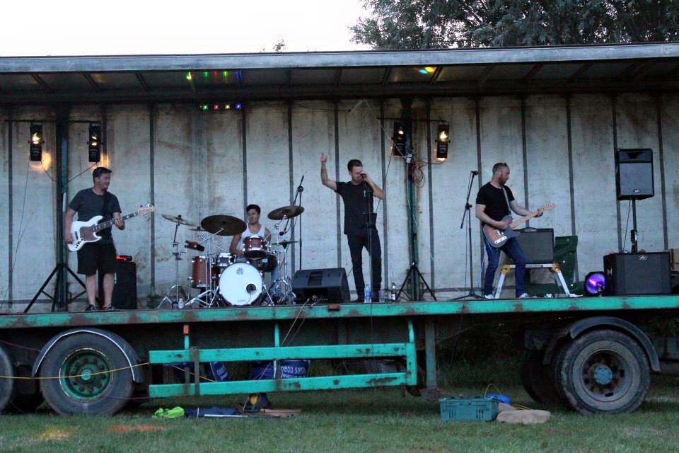 Jack performing with the band on an outdoor festival stage