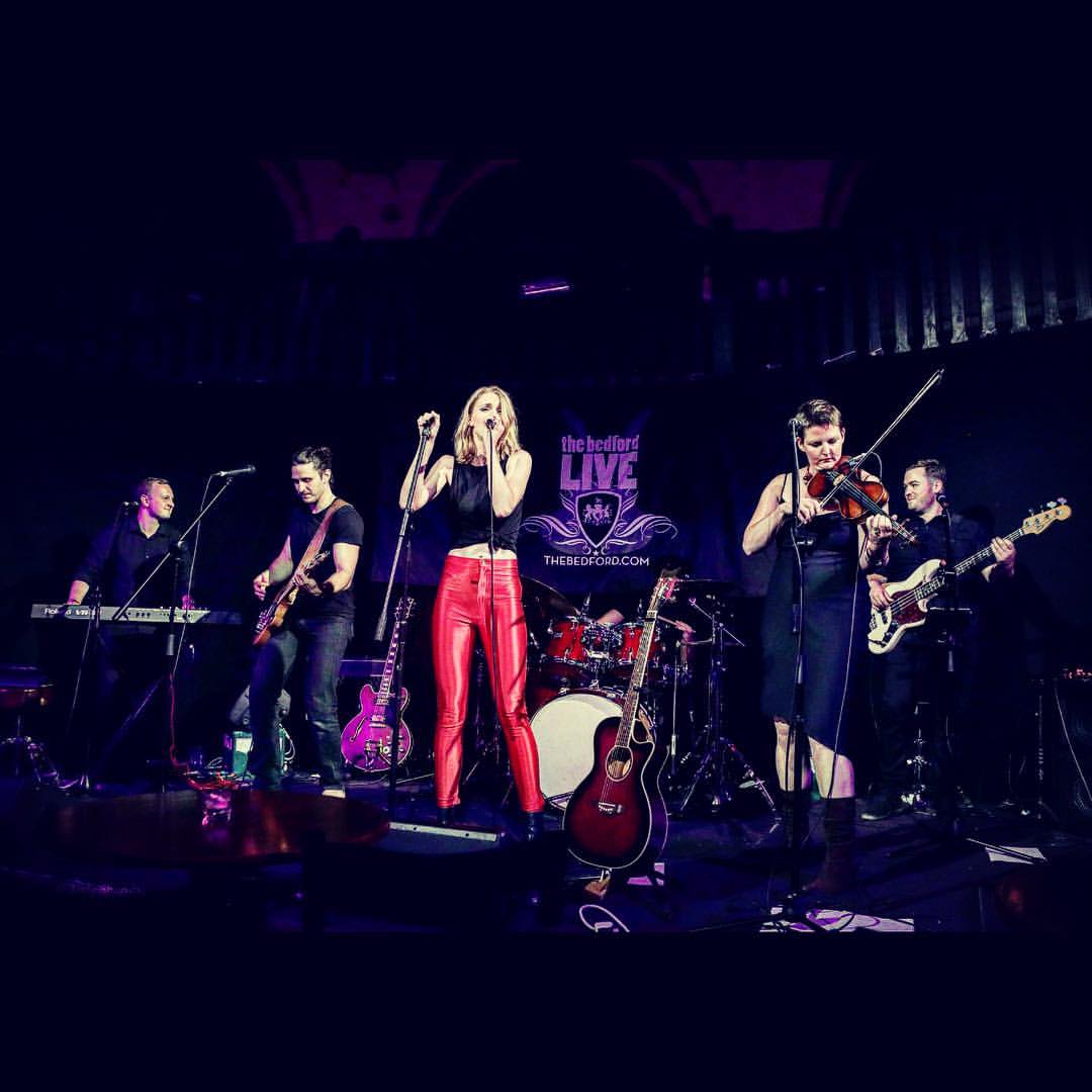 Function band performing live under coloured lights