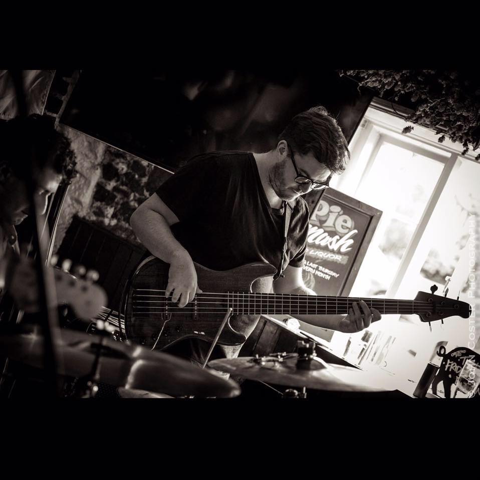 Jack locked in on his bass during a gig