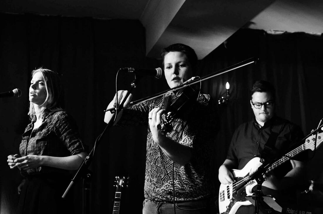 Jack on bass in a black-and-white live shot